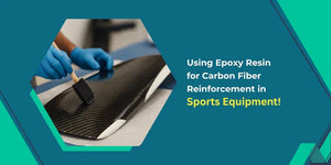 Worker applying epoxy resin with brush on carbon fiber material for sports equipment reinforcement