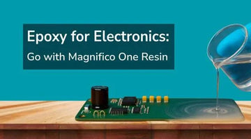 Gloved hand pouring clear epoxy resin onto electronic circuit board on wooden surface with blue background