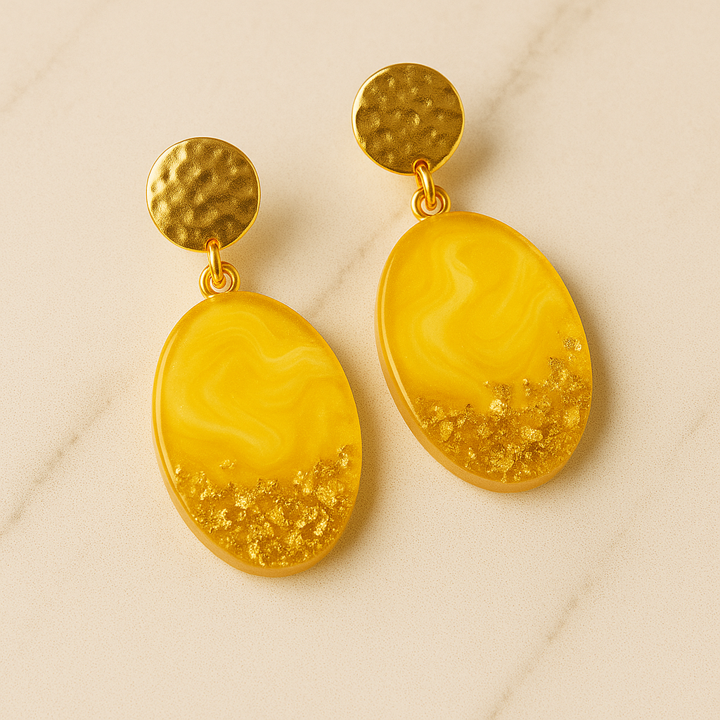Gold and yellow earrings on a beige background made with epoxy resin by Magnifico